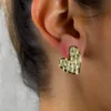 Golden-Passion-earrings-crafted-in-18k-gold-plated-bronze-with-a-wavy-pattern-that-evokes-movement-and-depth