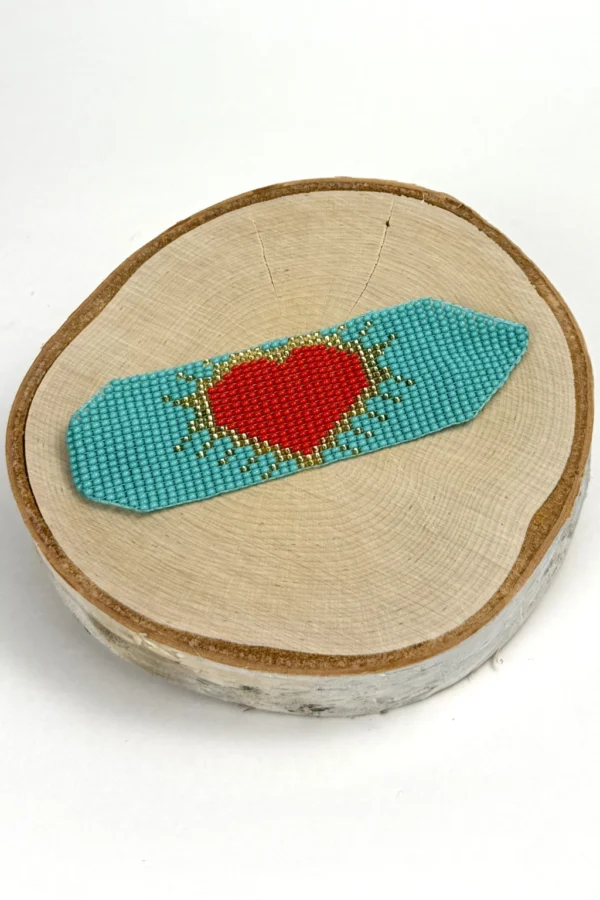 Heartbeat-of-the-Soul-bracelet-handwoven-in-Czech-beads-with-a-red-heart-design-on-a-vibrant-blue-background
