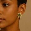 Natural-Essence-earrings-crafted-in-18k-gold-plated-bronze-with-a-young-emerald-at-the-center