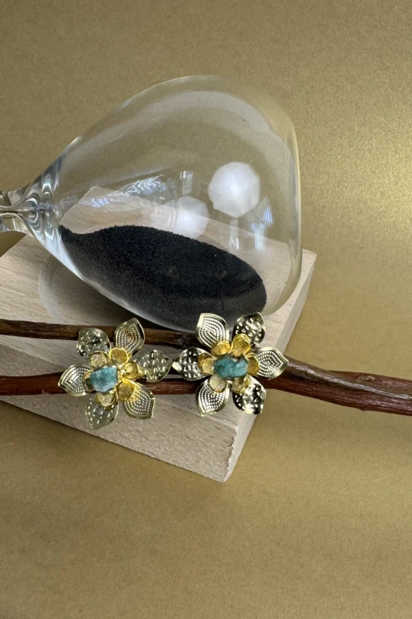 Natural-Essence-earrings-crafted-in-18k-gold-plated-bronze-with-a-young-emerald-at-the-center